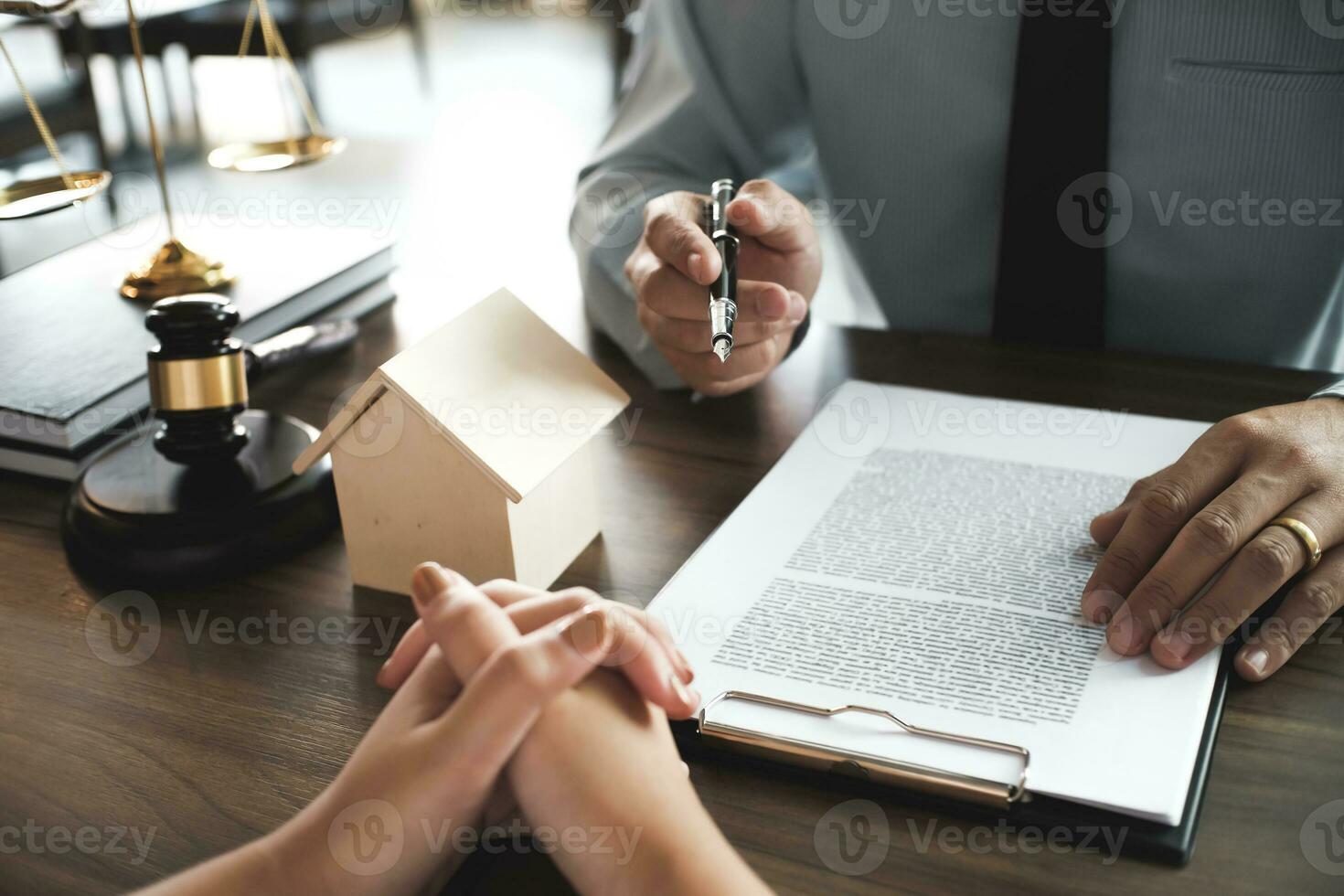Legal counsel presents to the client a signed contract with gavel and legal law. justice and lawyer concept. photo