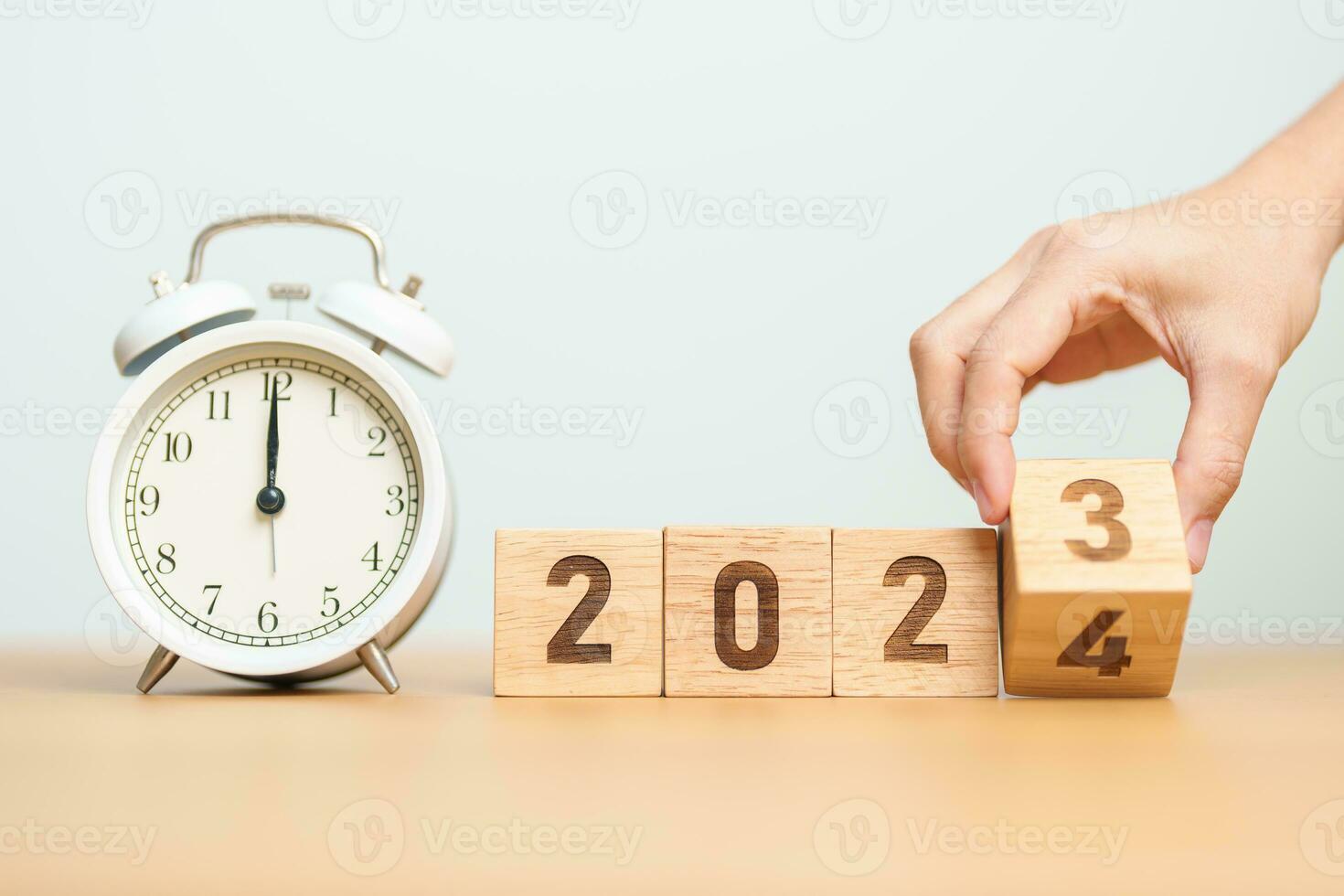 Happy New Year with vintage alarm clock and flipping 2023 change to 2024 block. Christmas, New Start, Resolution, countdown, Goals, Plan, Action and Motivation Concept photo