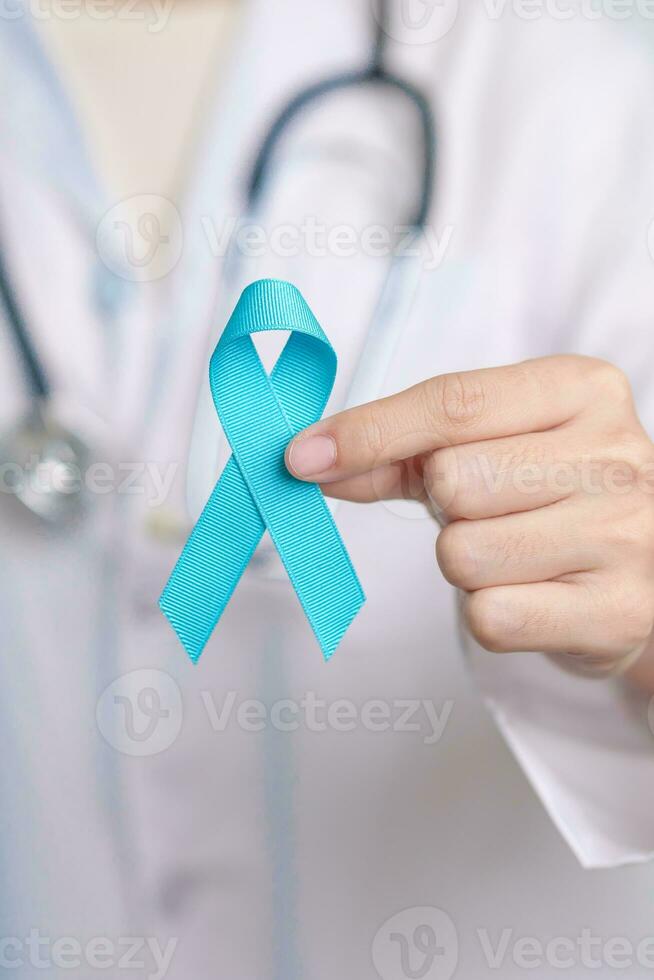 Blue November Prostate Cancer Awareness month, Doctor with Blue Ribbon in hospital for support people life and illness. Healthcare, International men, Father, Diabetes and World cancer day photo