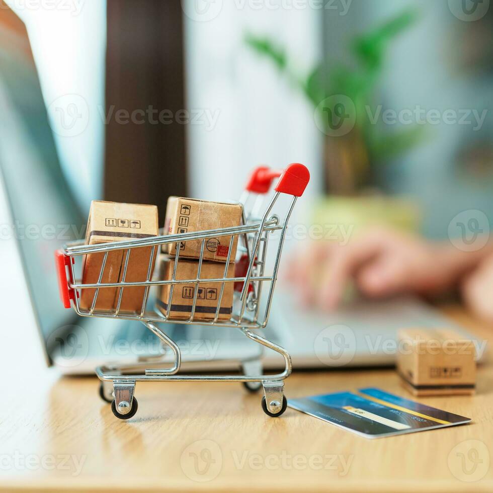 woman hand holding credit card and using laptop with mobile phone for online shopping while making order. Marketplace platform website, technology, ecommerce, shipping delivery and online payment photo
