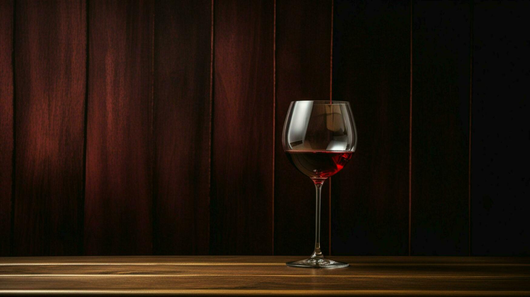 red wine glass elegance on wood table photo