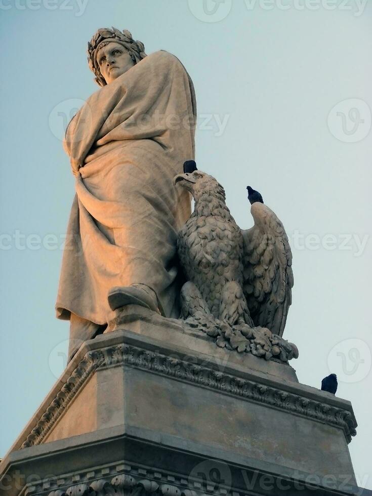 Monument to Dante Alighieri on Holy Cross za di Santa Croce in Florence. Italy. The greatest Italian poet, author of the Divine Comedy, the work of sculptor Enrico PazziSquare Piaz. photo