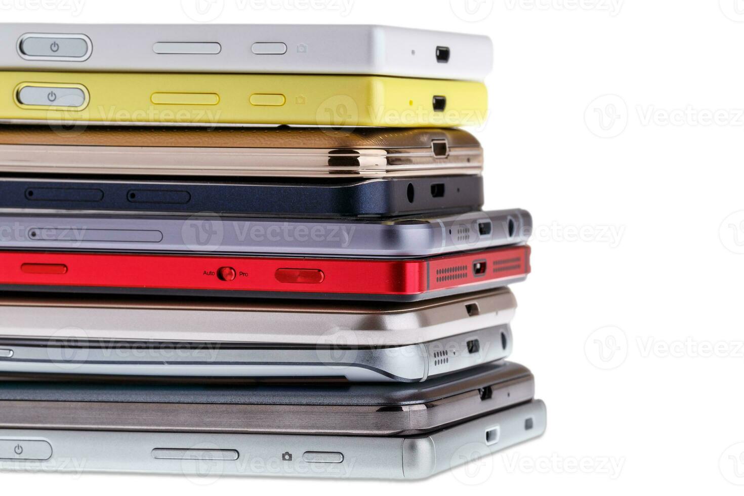 Pile of mobile phone. Heap of the different smartphones isolated on white background. photo