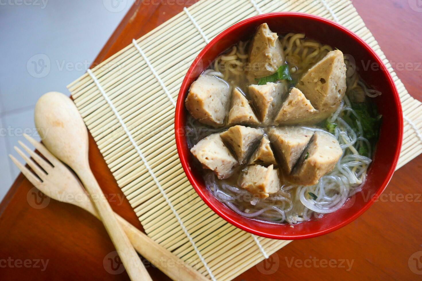 Bakso urat or meatball muscles is popular traditional food made from meat and cow muscles served with vegetables, noodle and flavour soup served on bowl photo