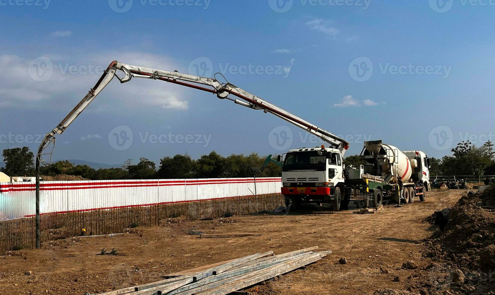 casting concrete using a Mixer Truck then using a concrete pump to push the processed concrete liquid from the mixer truck photo