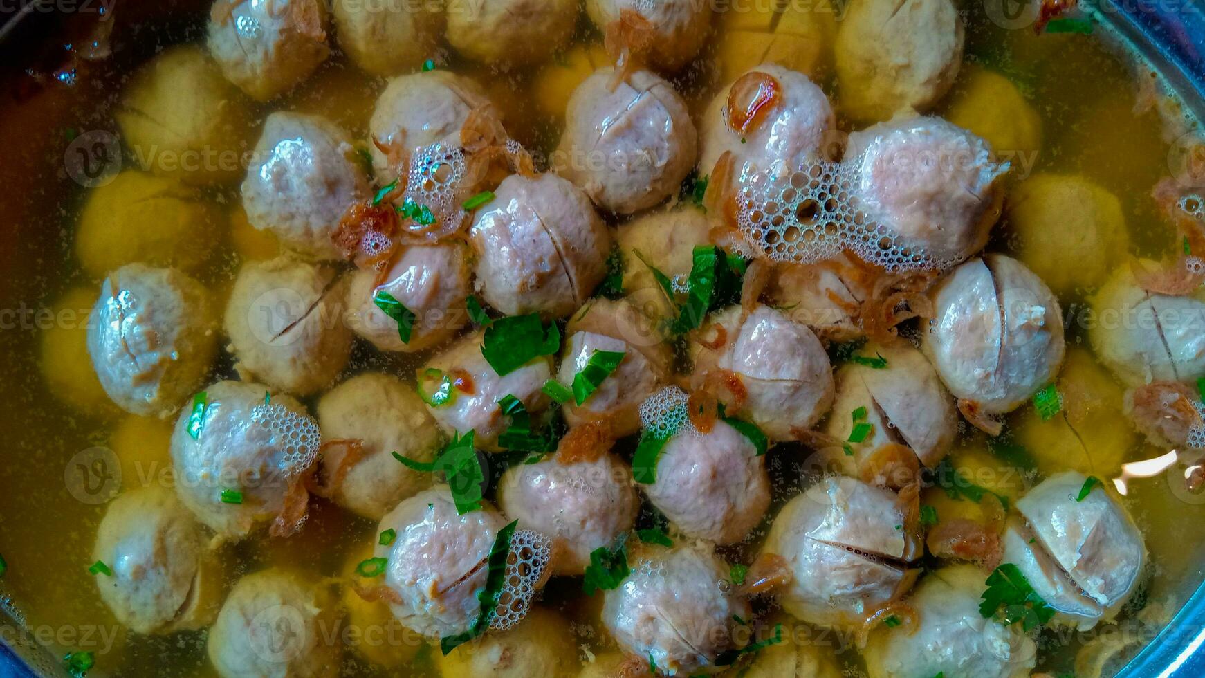 Bakso urat or meatball muscles is popular traditional food made from meat and cow muscles served with vegetables, noodle and flavour soup served on bowl photo