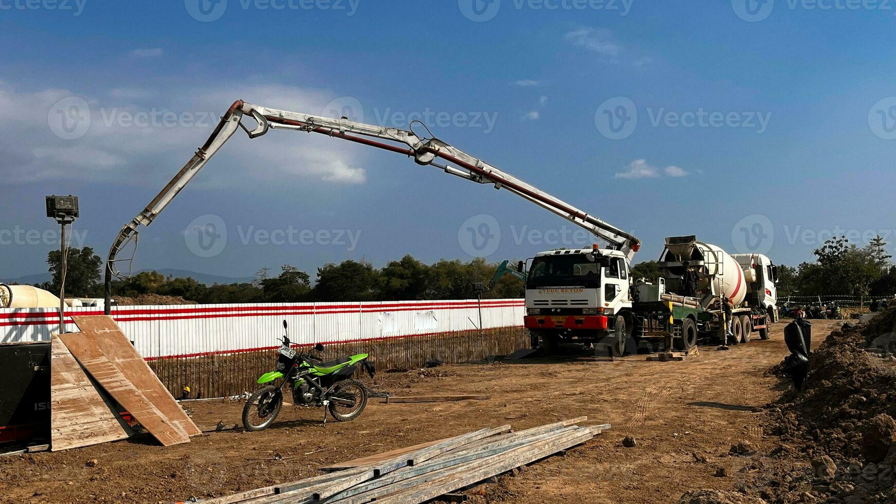 casting concrete using a Mixer Truck then using a concrete pump to push the processed concrete liquid from the mixer truck photo