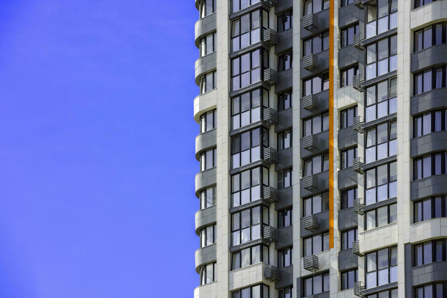 freshly built high rise apartment building on blue sky background photo