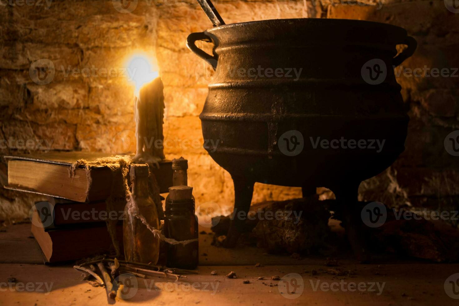 spell of witch night with candles and pot with fire between cobwebs and ancient earth photo