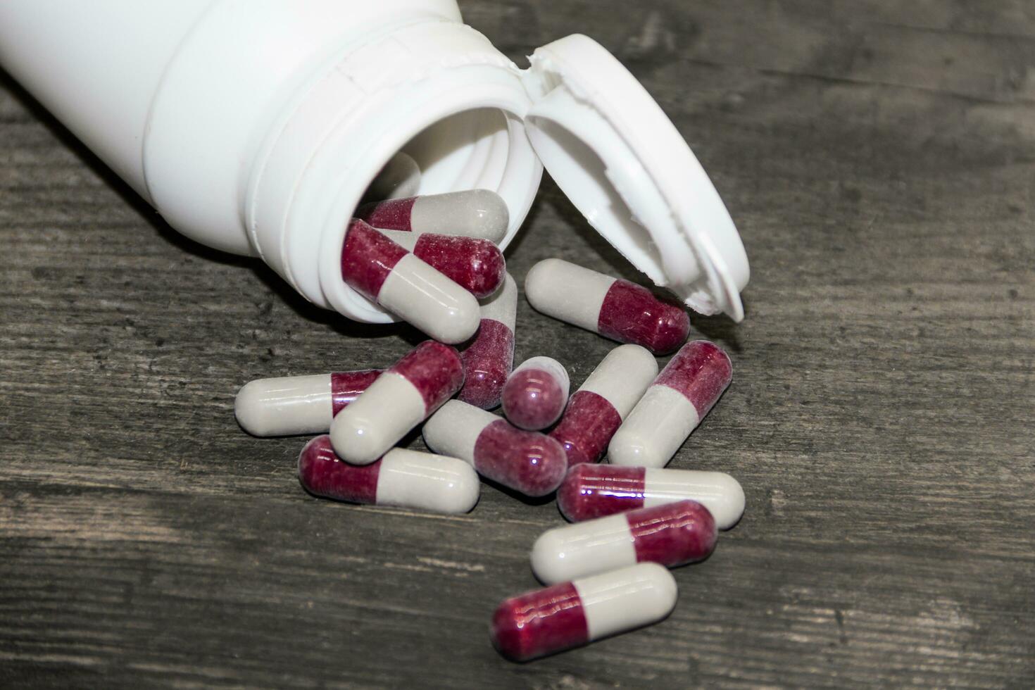 Detail of a bottle of capsules with medical drugs.Concept Medicine, health photo