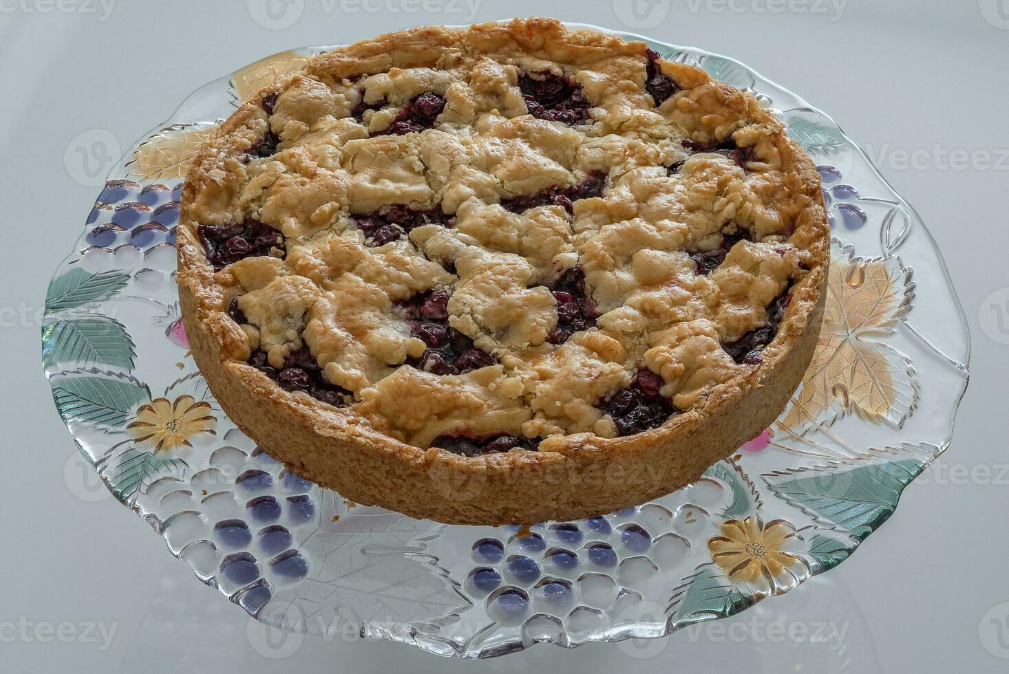 Cherry cake closeup made at home on a colored glass stand photo