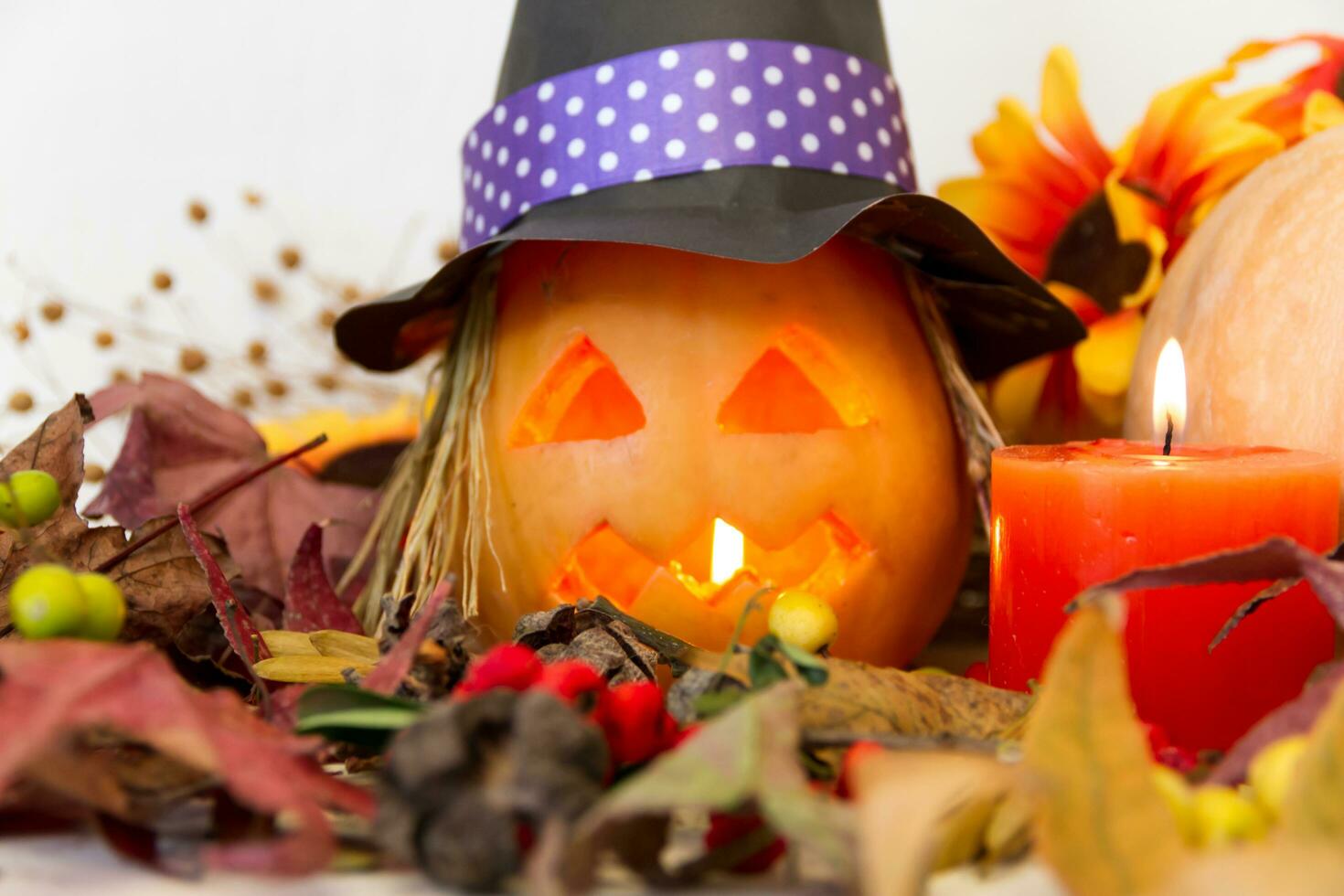 candles and decoration with halloween pumpkins with witch faces and witch photo