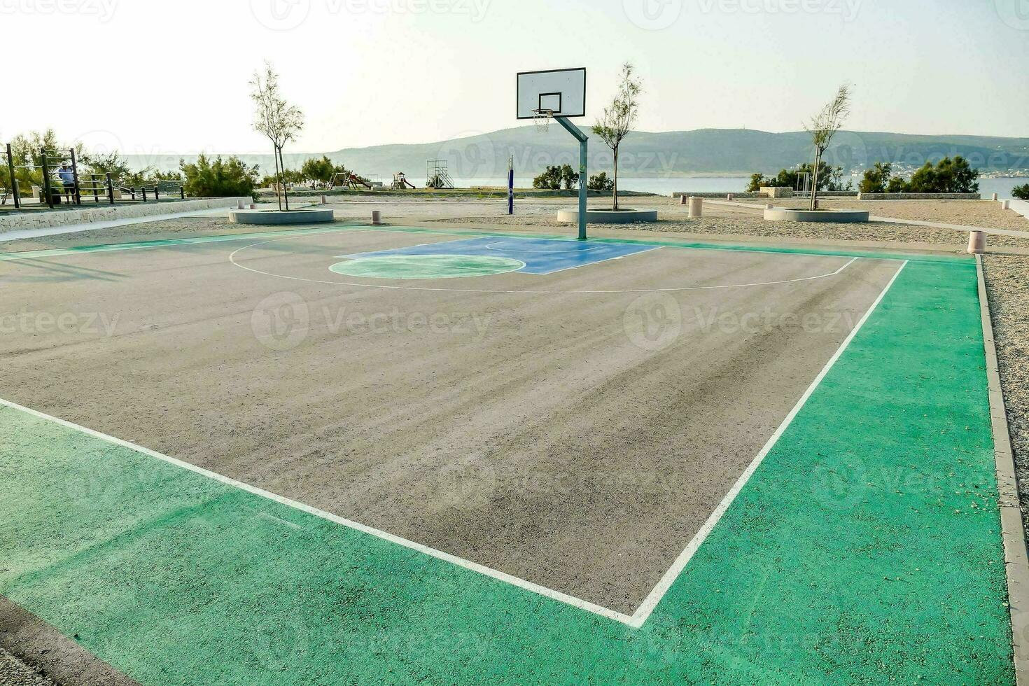 an empty basketball court with a green paint photo