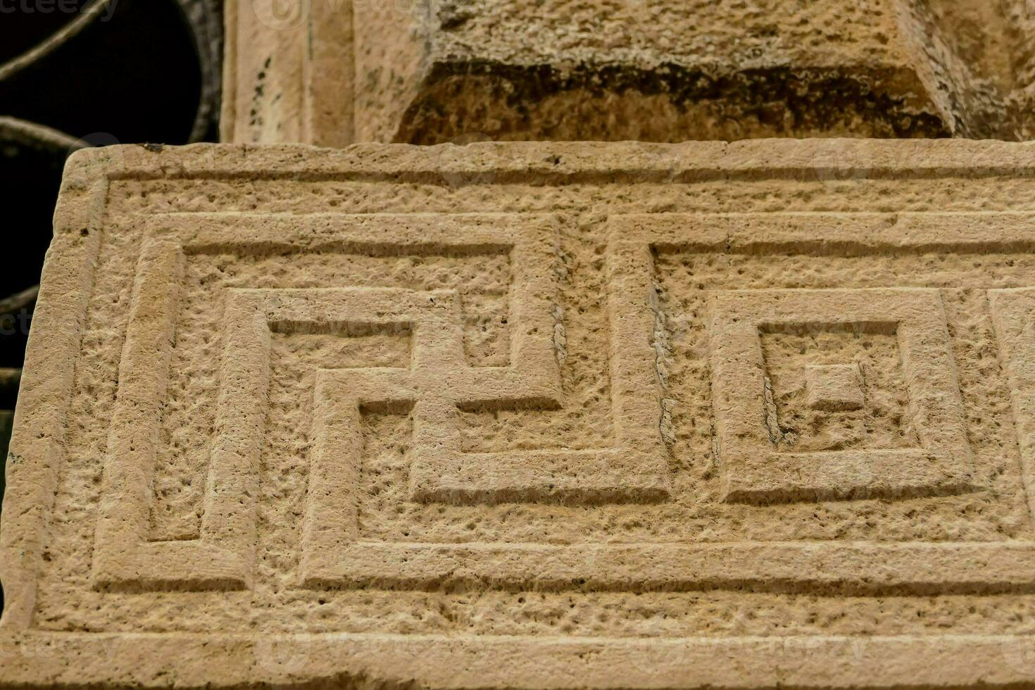 a stone block with a greek design on it photo