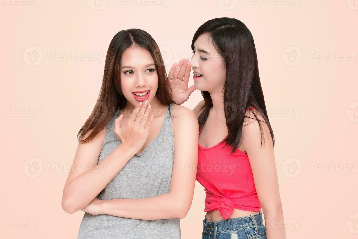 Two women whispering and smiling photo
