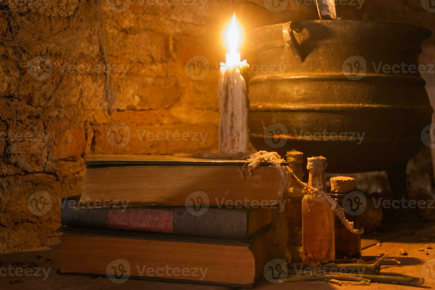 spell of witch night with candles and pot with fire between cobwebs and ancient earth photo