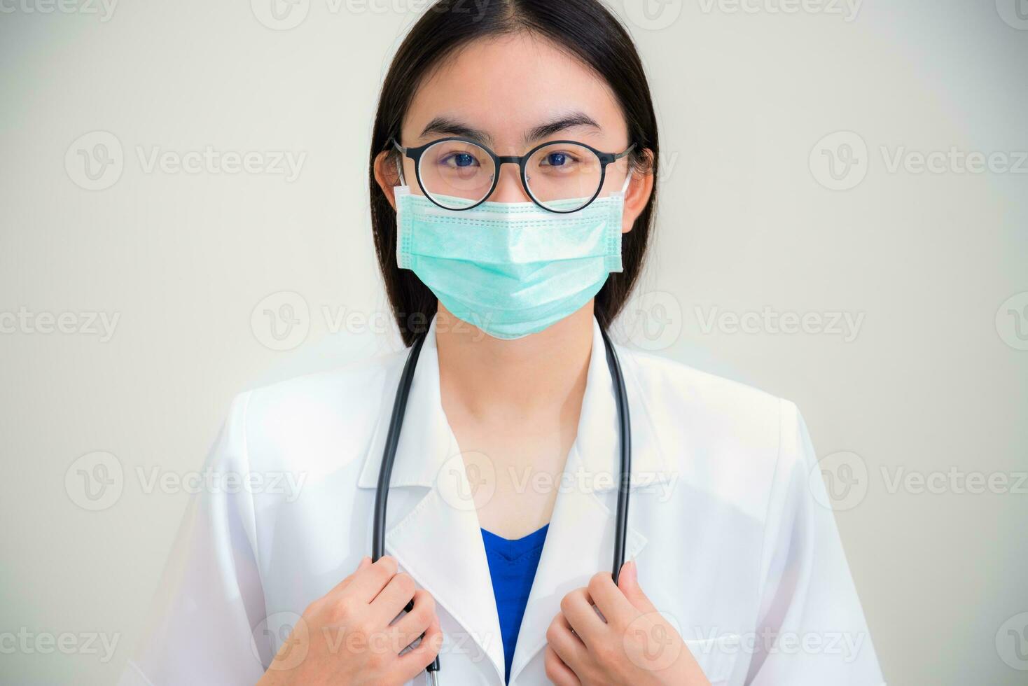 Woman doctor with stethoscope in white uniform photo