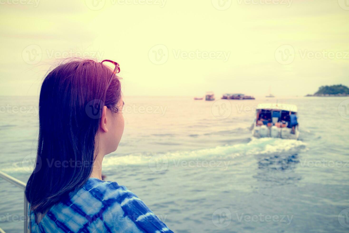 Woman looking at the boat that sailed away from her in vintage style photo