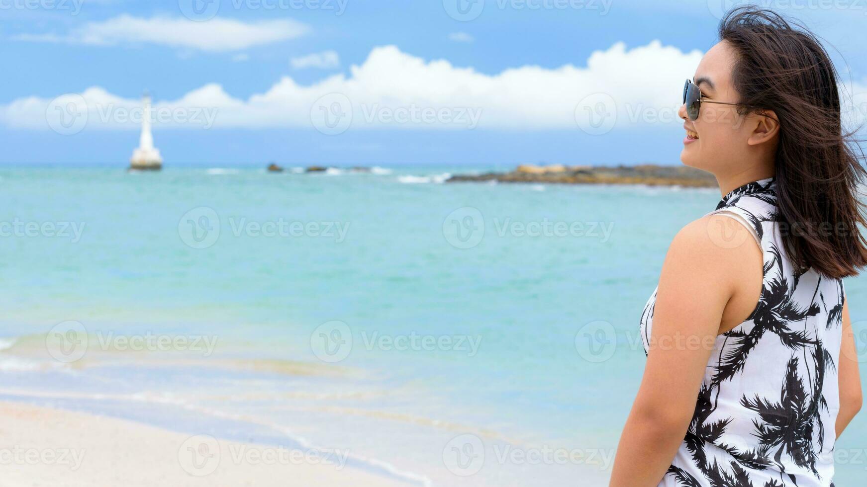 Beautiful woman tourist on the beach in Thailand photo