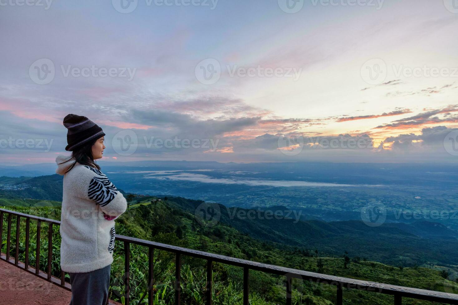 Woman tourist watching the sunrise photo