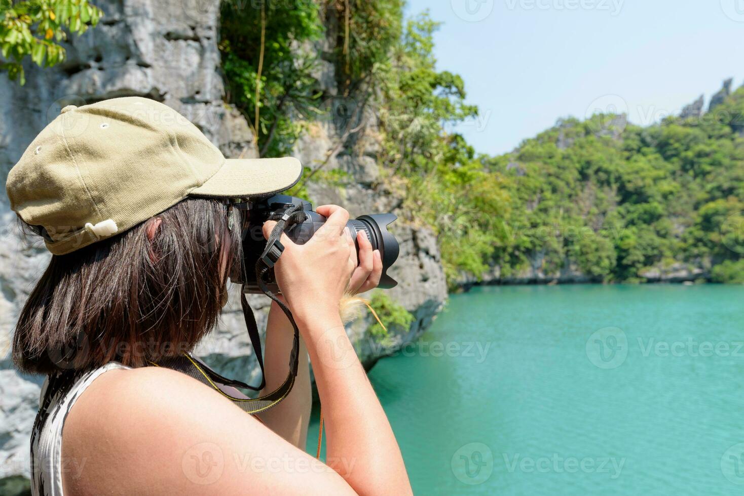 Woman tourist taking photos Thale Nai