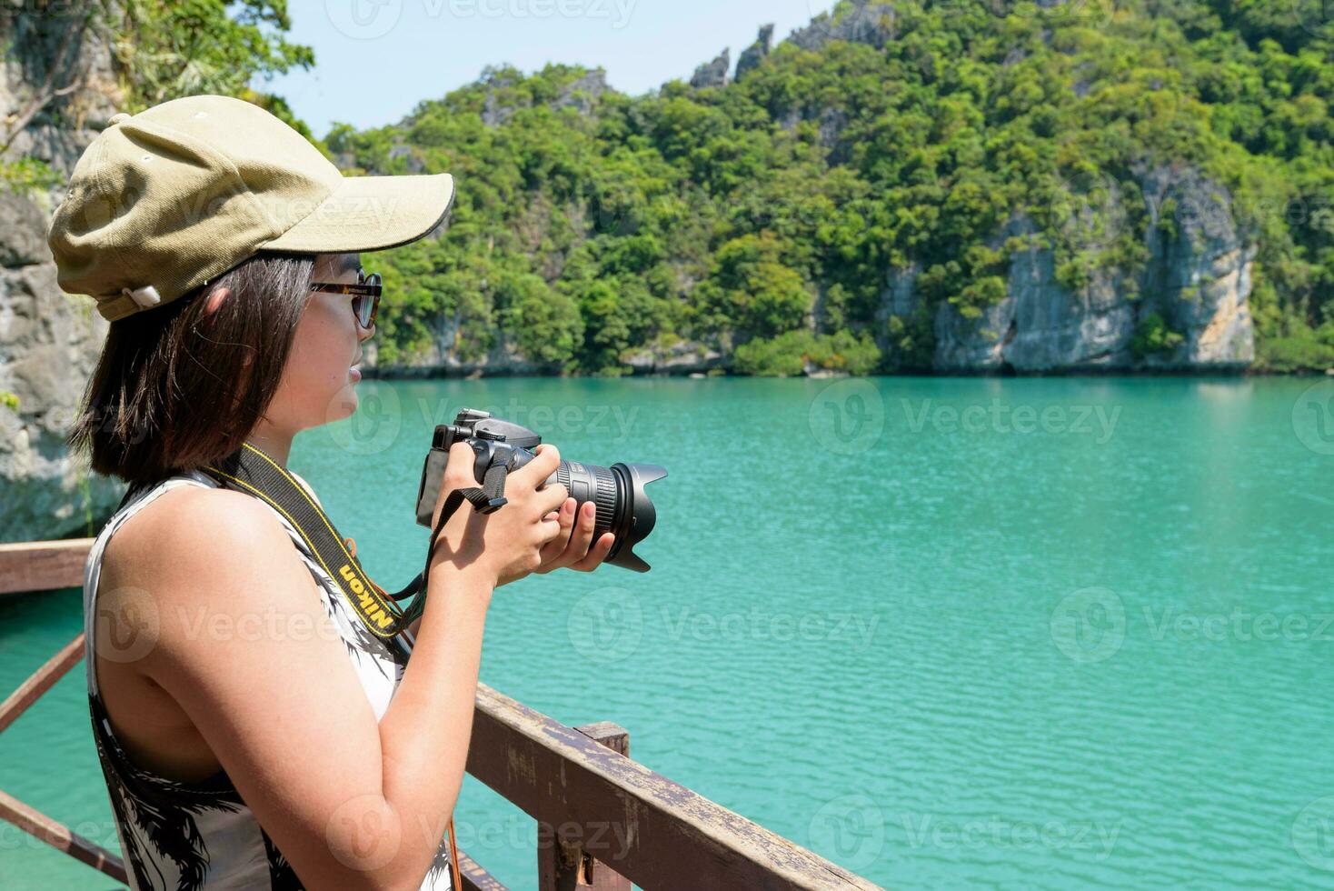 Woman tourist taking photos Thale Nai