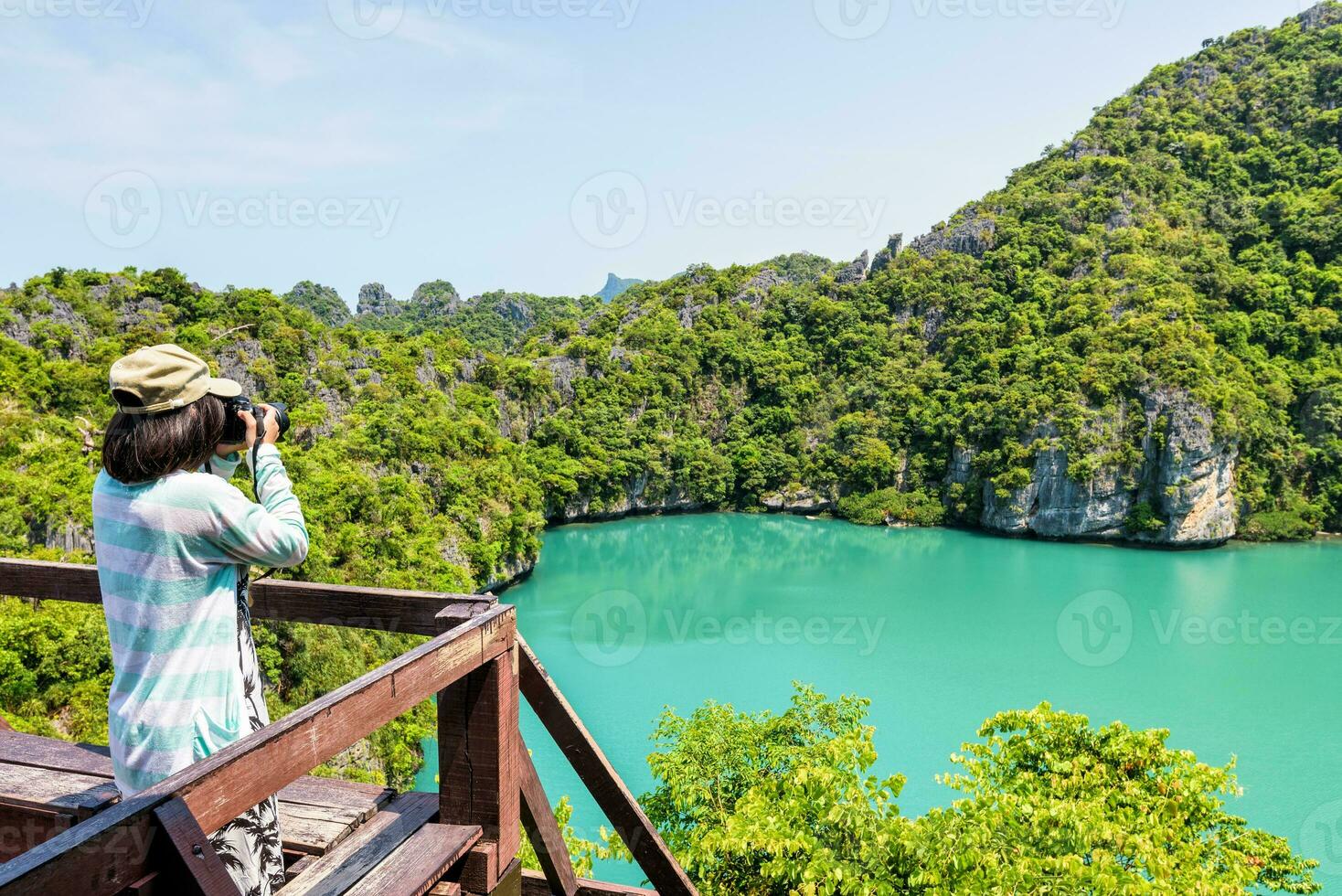 Woman tourist taking photos of Thale Nai
