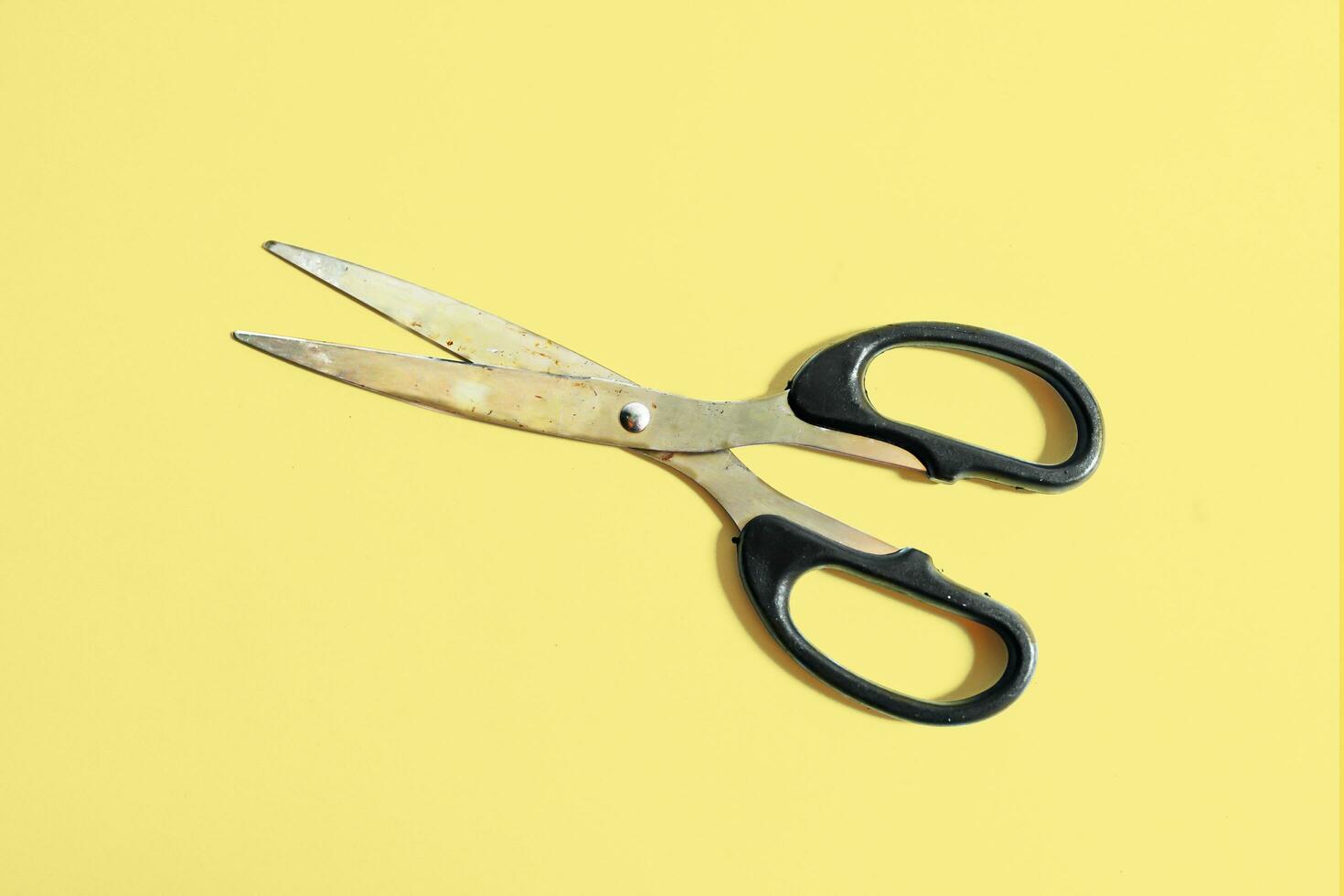 Stylish Professional Barber Scissors, Cutting Hair on a yellow background photo
