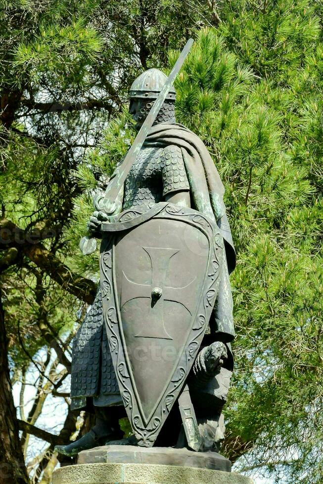 a statue of a knight holding a shield and sword photo