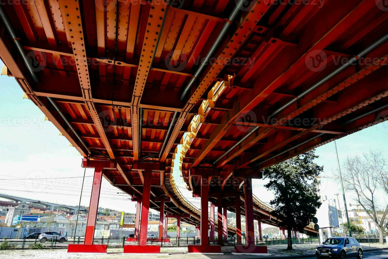 a red bridge with a car driving under it photo
