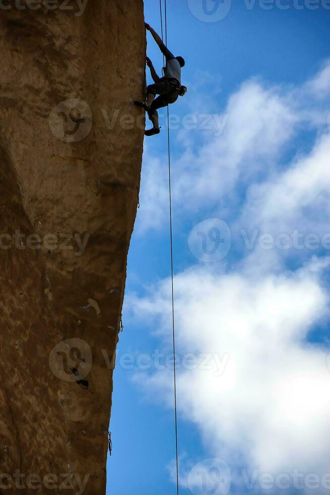 Climber  on  overhanging  cliff of Monkey Face photo