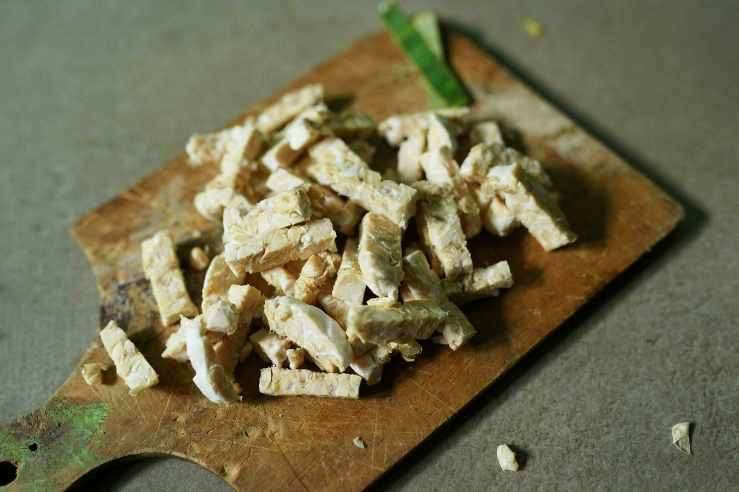 Indonesian food, raw tempeh sliced into squares on a concrete background photo