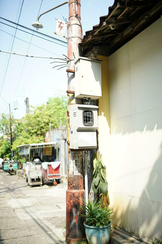 transformers and electricity poles in the morning located in the middle of the village photo