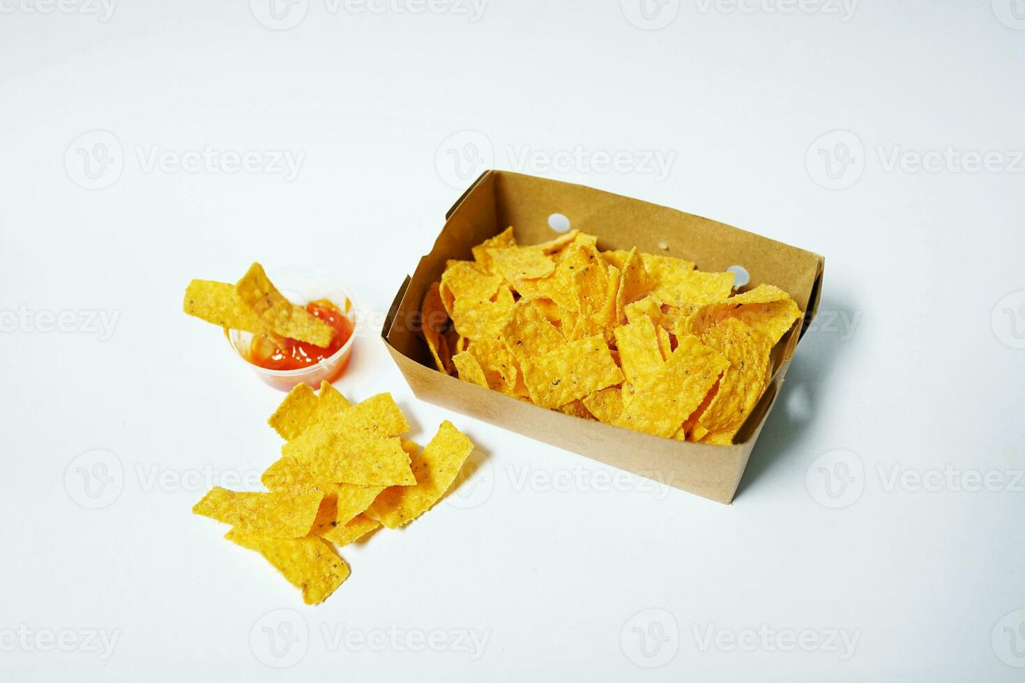 Corn chips in a paper box on a white background photo