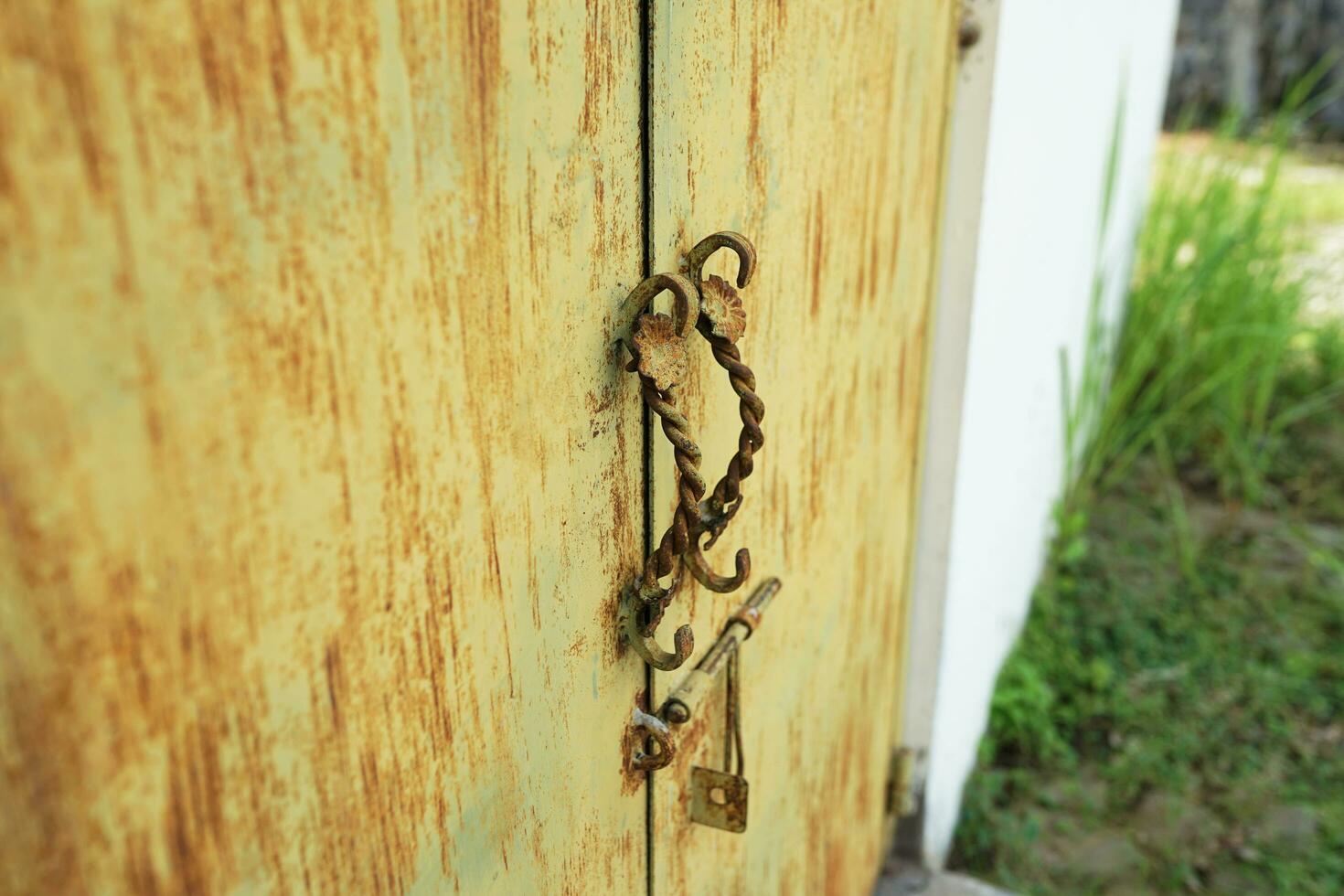 building exteriors. yellow metal door with classic door handle photo
