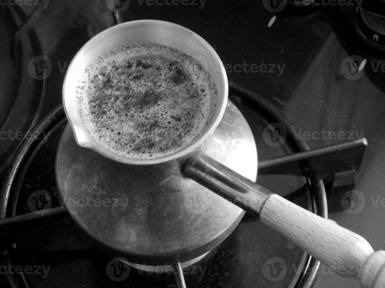 Barista preparing hot tasty drink from copper turk photo