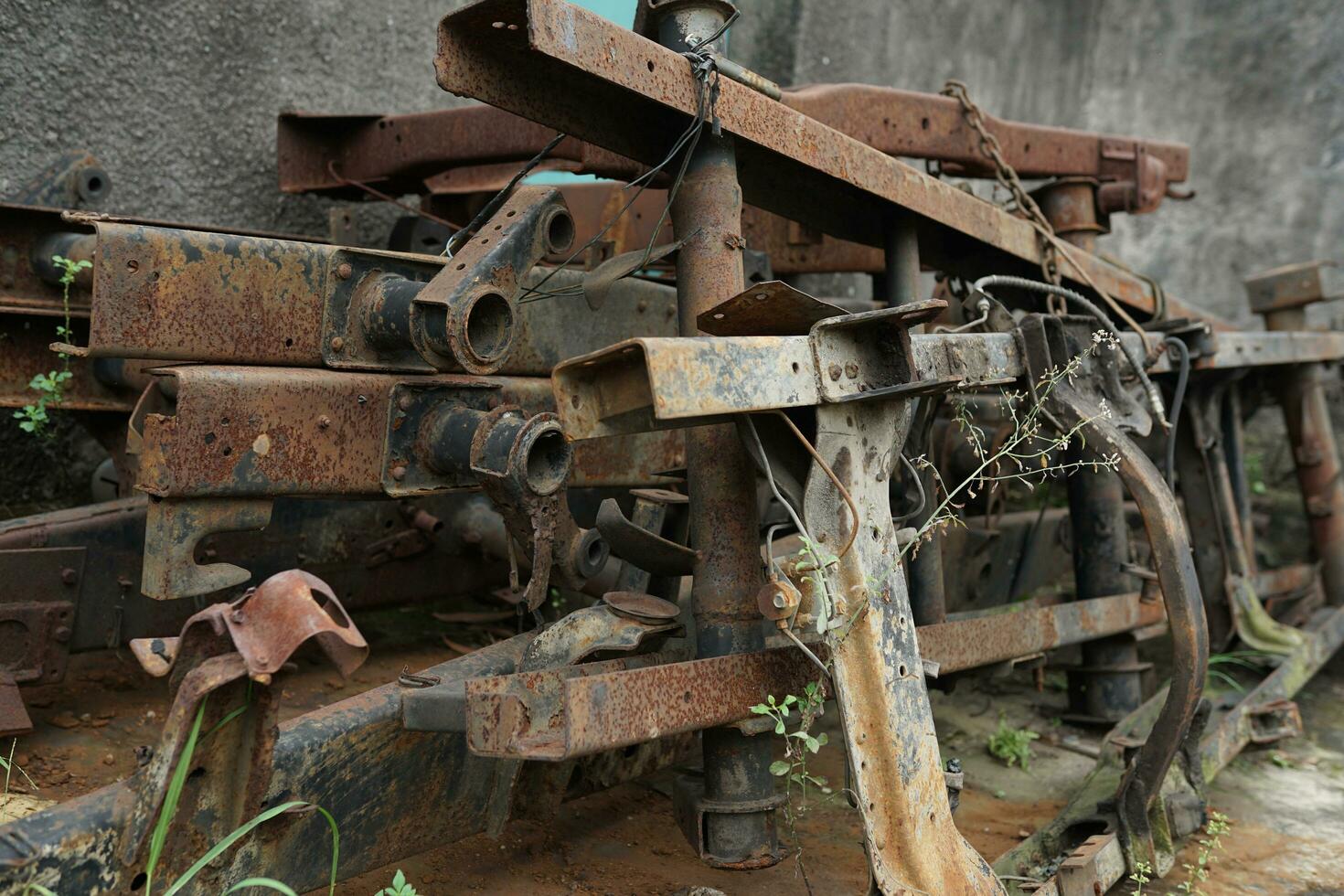 collection of broken metal truck chassis for sale at a junk metal shop photo