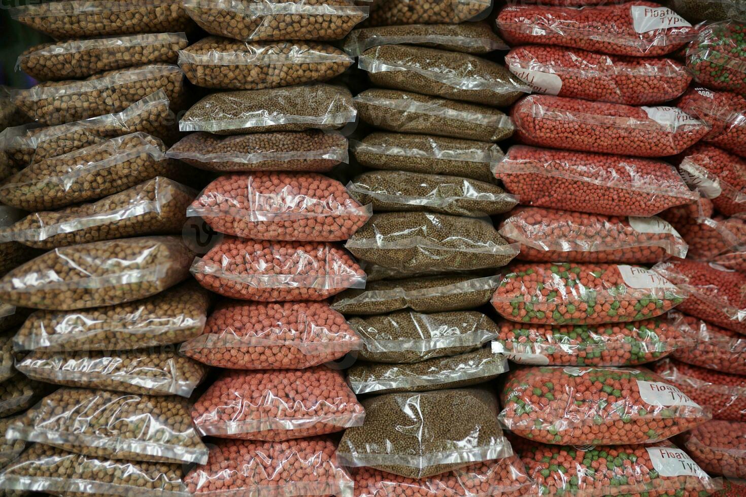 animal market, red colorful farm animal feed pellets. bird and fish feed in packaged form photo