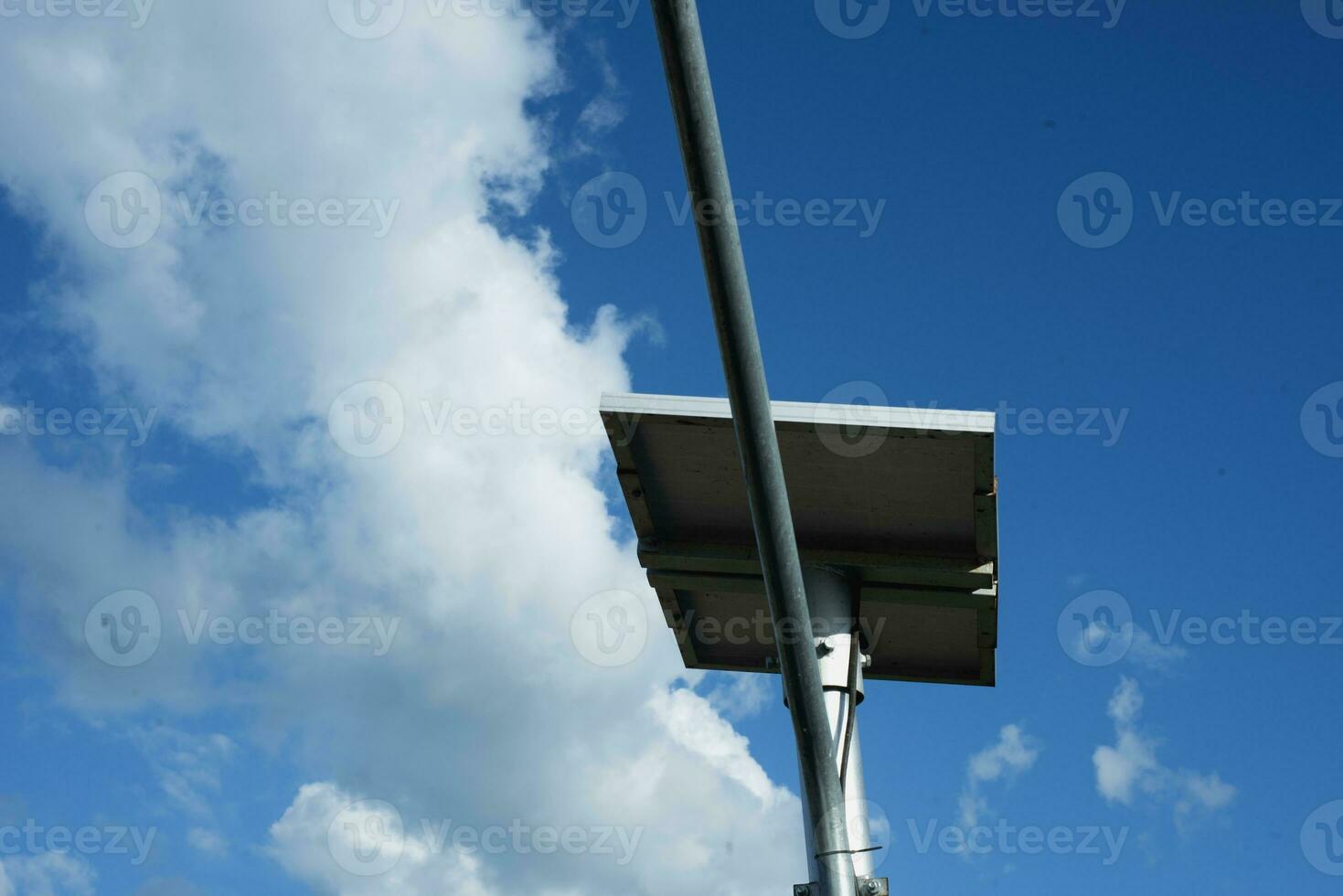 Small self-contained solar panel powered outdoor lighting pole or new technologies and energy trends for urban public spaces. Small solar power plant. photo