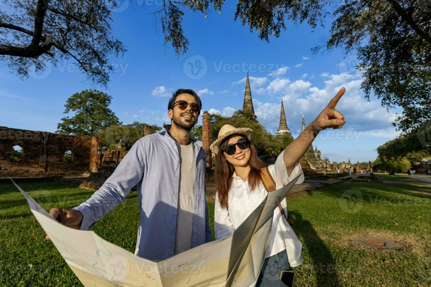 Couple of tourist come to visit at Wat Phra Si Sanphet temple, Ayutthaya Thailand using maps for travel, vacation, holiday, honeymoon and tourism photo