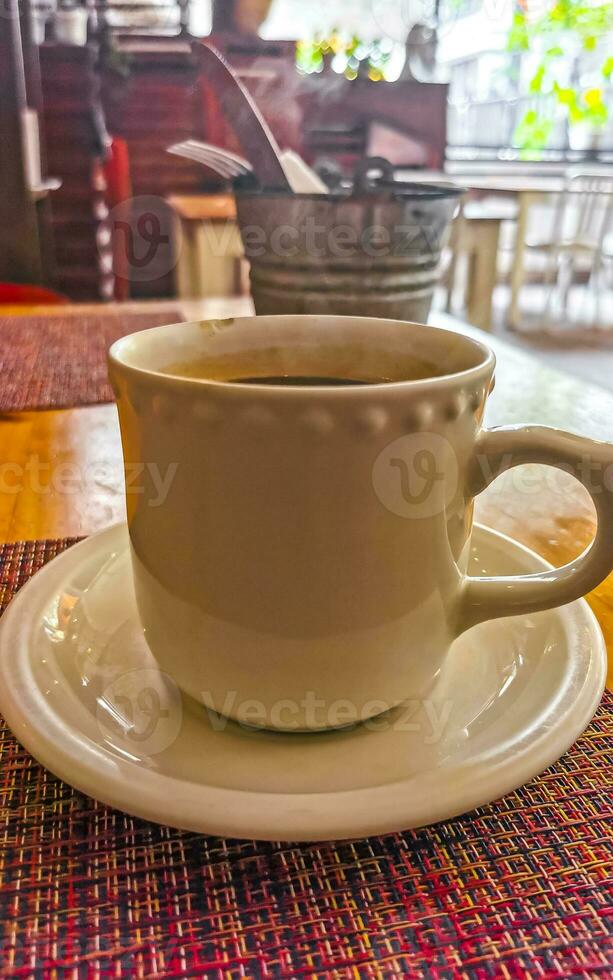 Cup of americano black coffee in restaurant Mexico. photo