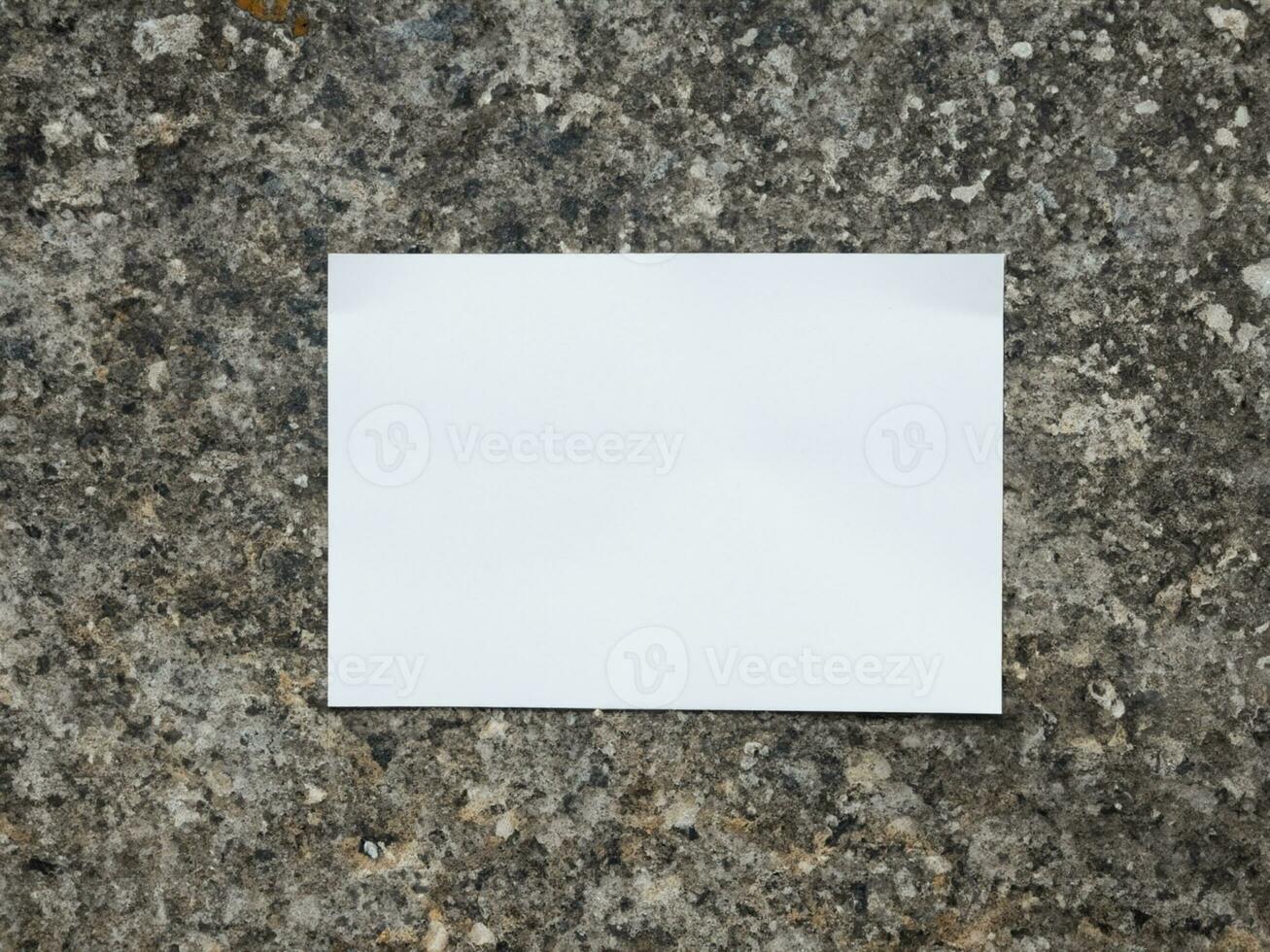 blank paper card on stone wall background photo