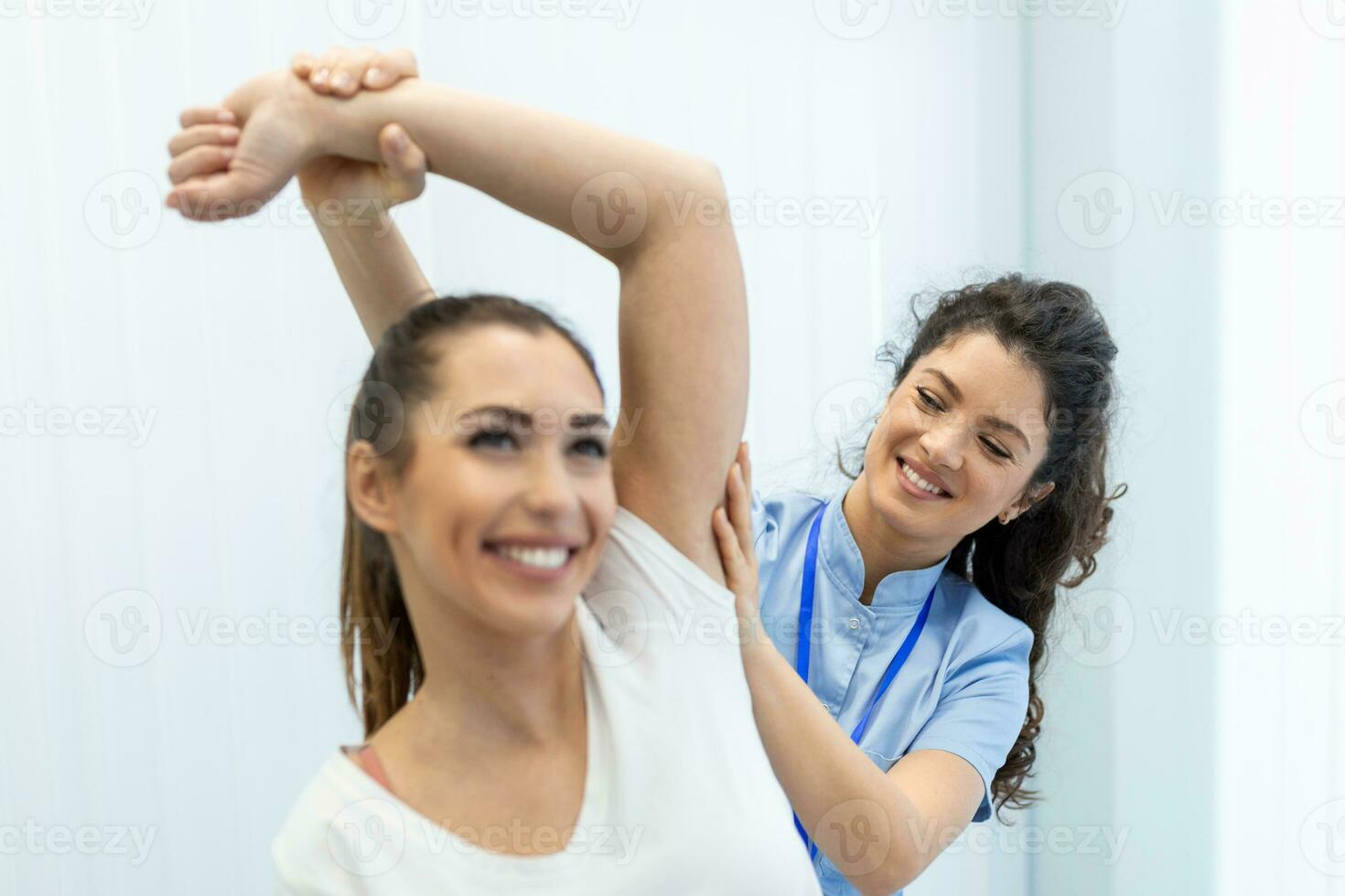 Doctor or Physiotherapist working examining treating injured arm of athlete patient, stretching and exercise, Doing the Rehabilitation therapy pain in clinic. photo