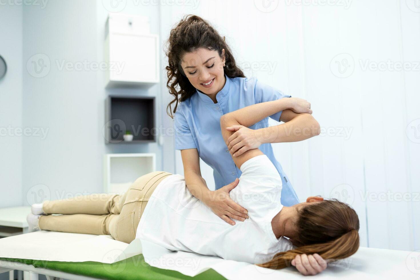 Physiotherapist treatment patient. Holding patient's hand, shoulder joint treatment. Physical Doctor consulting with patient About Shoulder muscule pain problems Physical therapy diagnosing concept photo