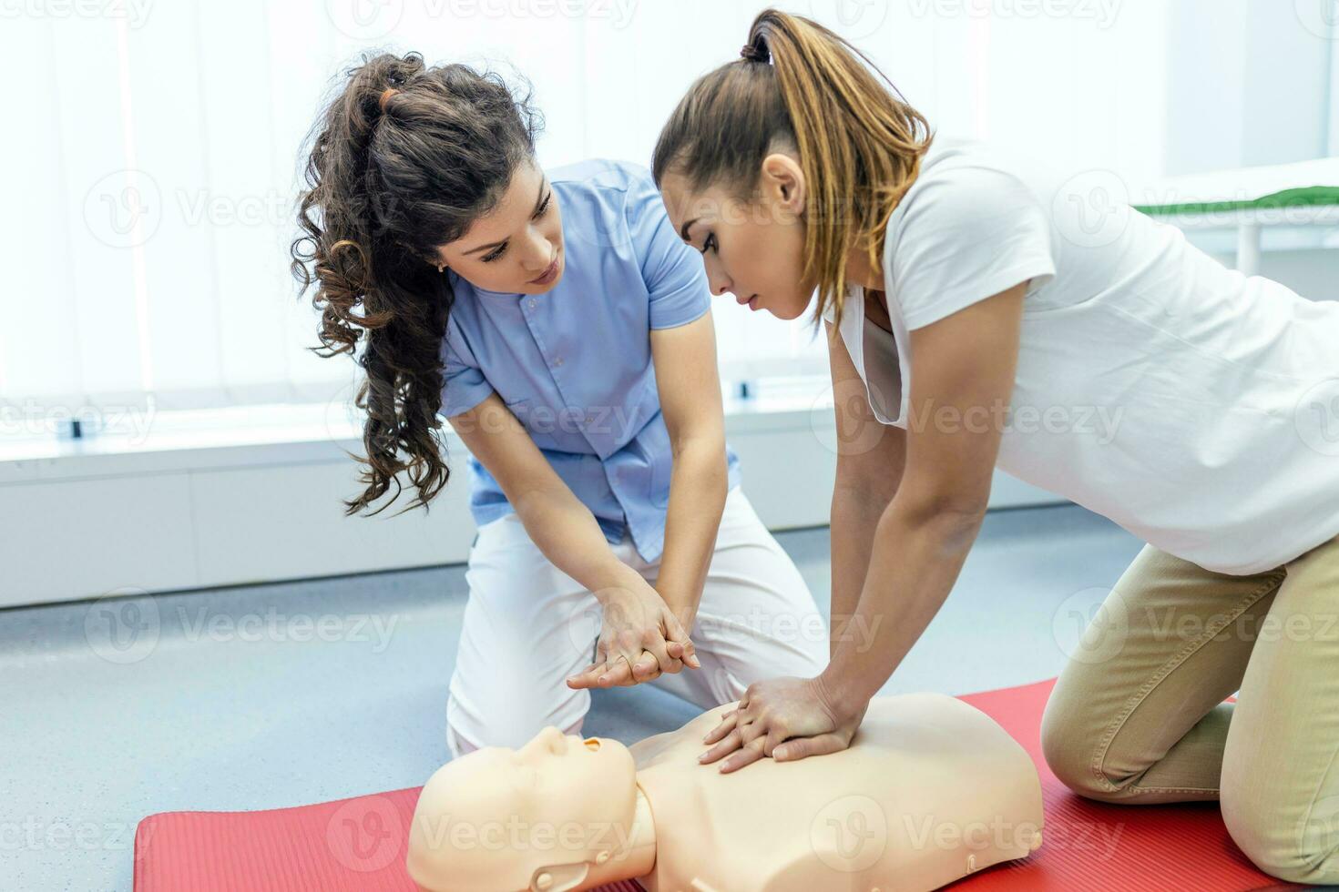 Demonstrating CPR Cardiopulmonary resuscitation  training medical procedure on CPR doll in the class.Doctor and nurse students are learning how to rescue the patient.First aid for safe life concept. photo