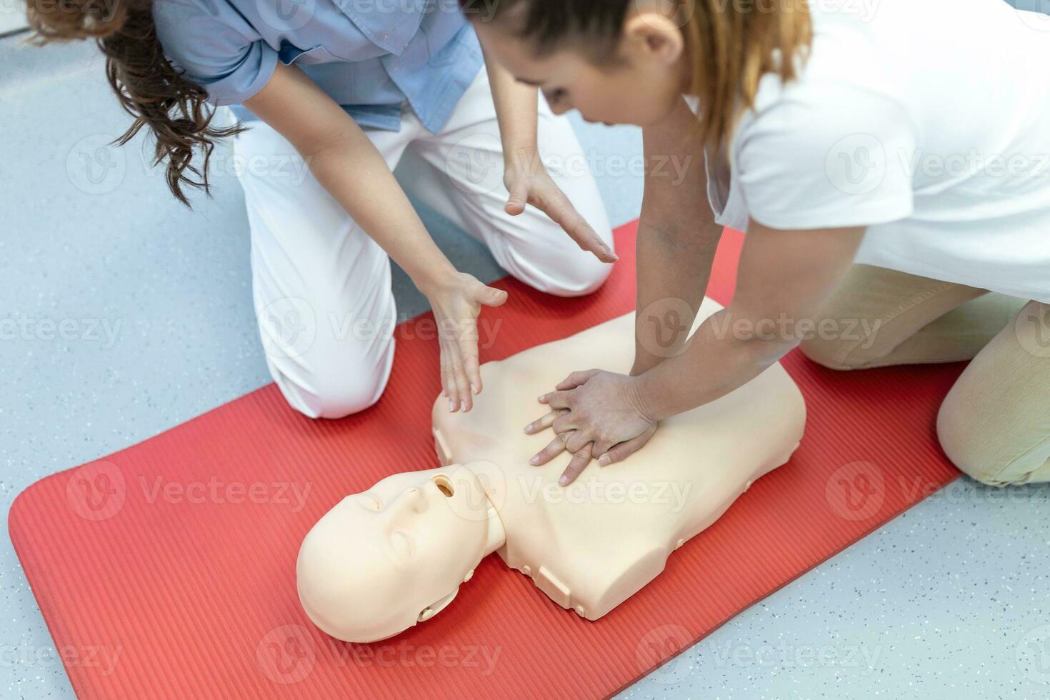 Demonstrating CPR Cardiopulmonary resuscitation  training medical procedure on CPR doll in the class.Doctor and nurse students are learning how to rescue the patient.First aid for safe life concept. photo