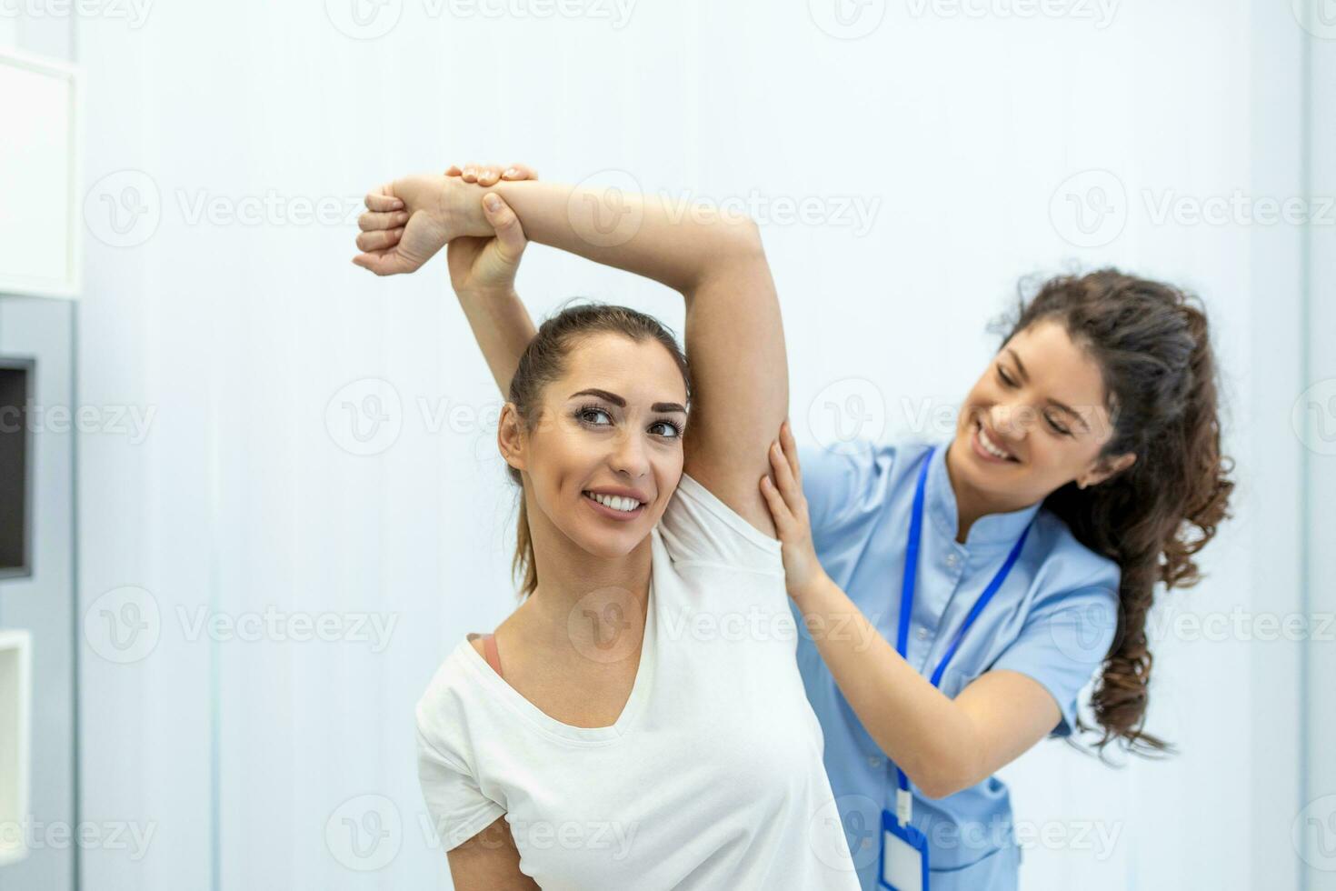Doctor or Physiotherapist working examining treating injured arm of athlete patient, stretching and exercise, Doing the Rehabilitation therapy pain in clinic. photo