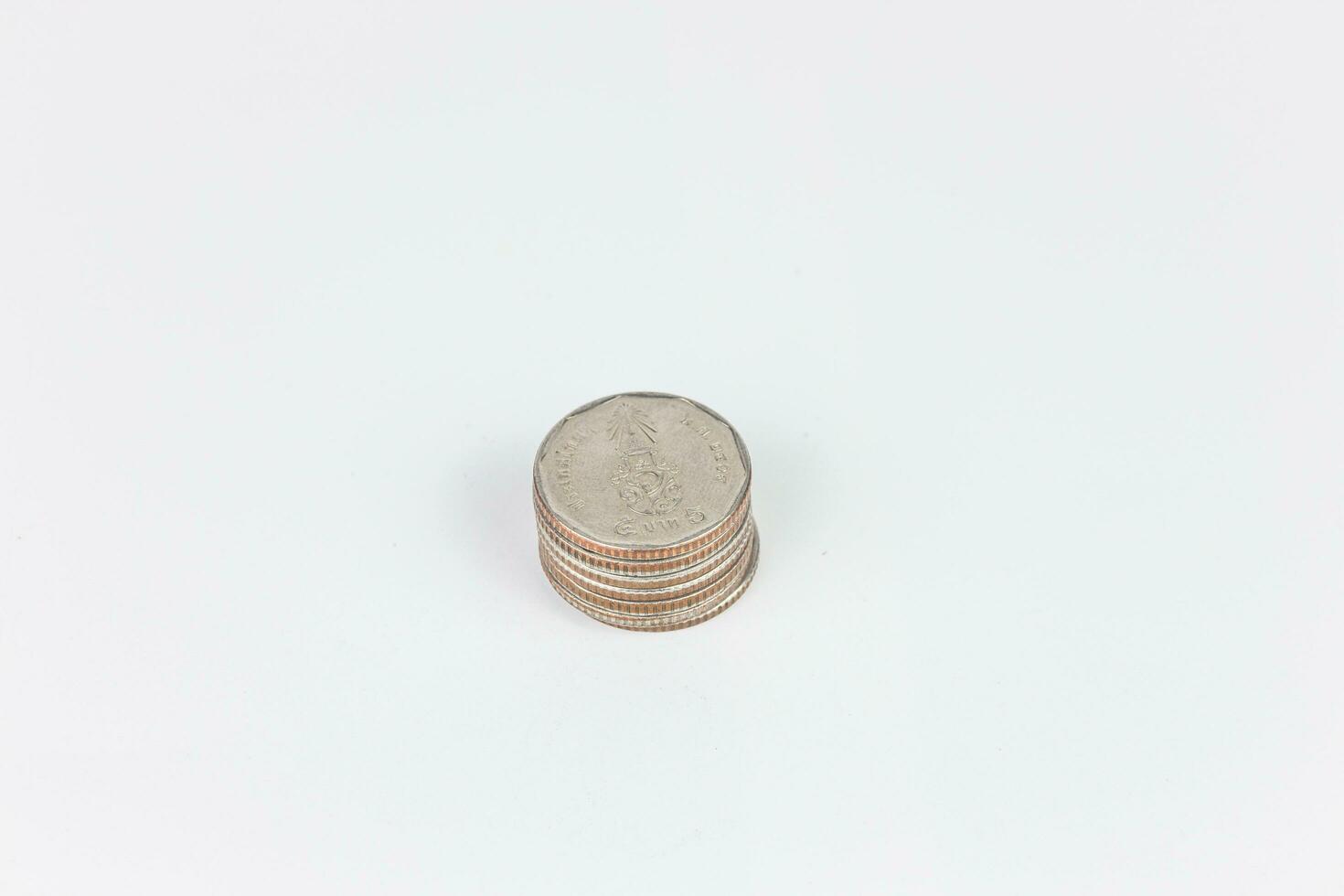 Coins stacked on each other on a white background, business concept photo