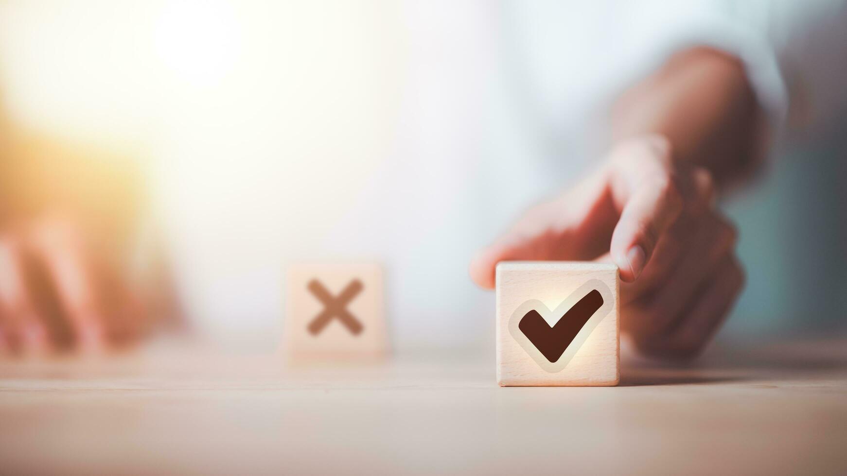 businessman selects wooden block with check mark icon symbol ,best alternative decision idea ,solution that has been analyzed ,Looking for new paths and opportunities ,Qualification for Measurement photo