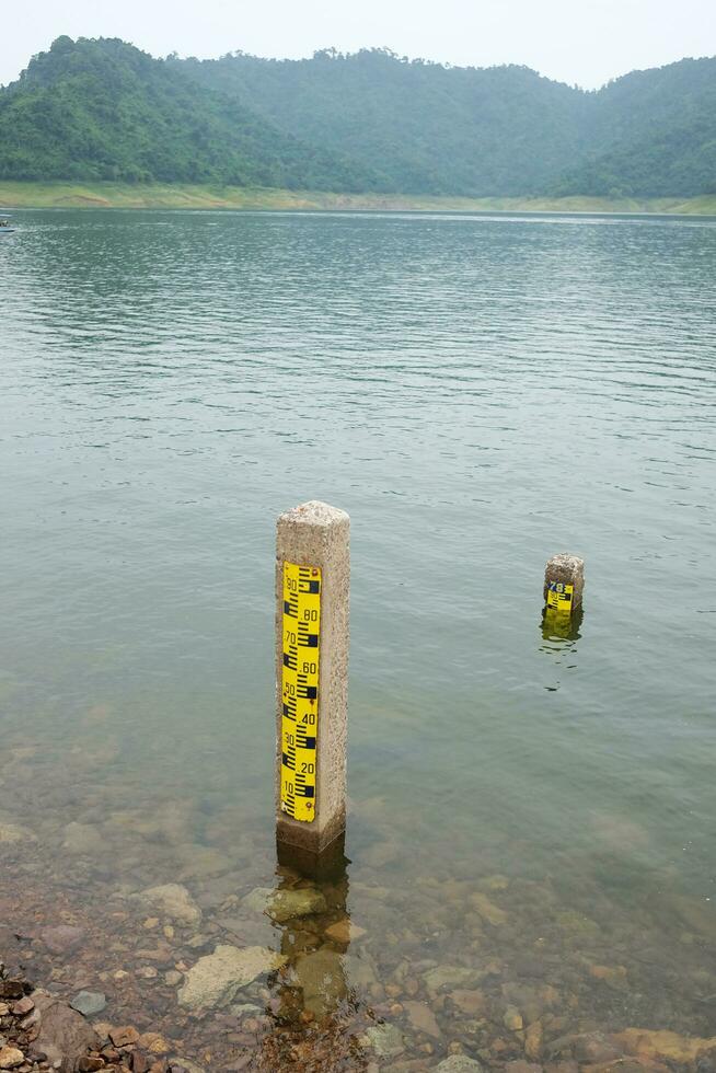 concrete poles used to measure the level of water and river in the dam of Thailand. photo